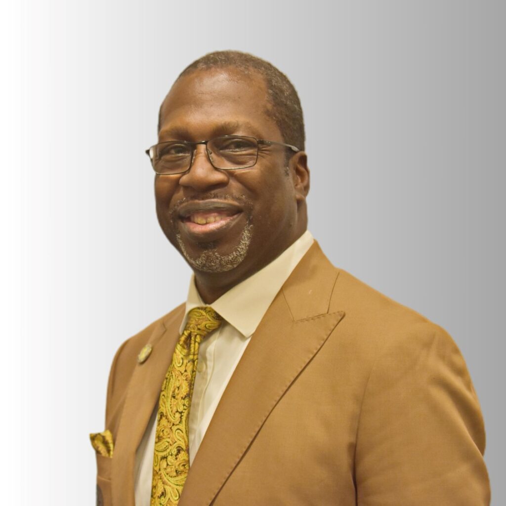 Portrait of smiling man in brown suit.