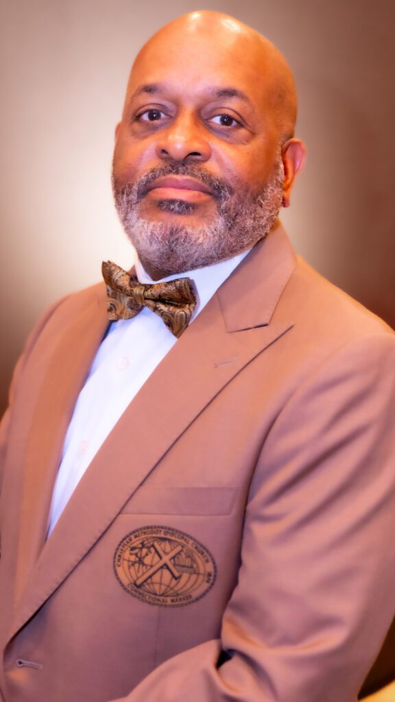 Portrait of a man in a suit and bow tie.