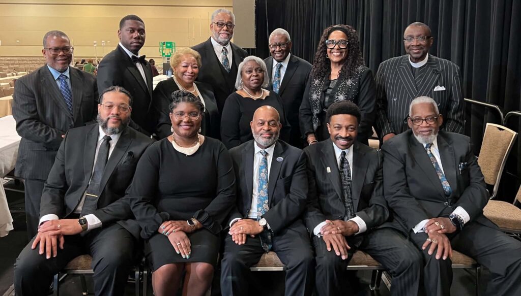 Group of formally dressed professionals posing at event